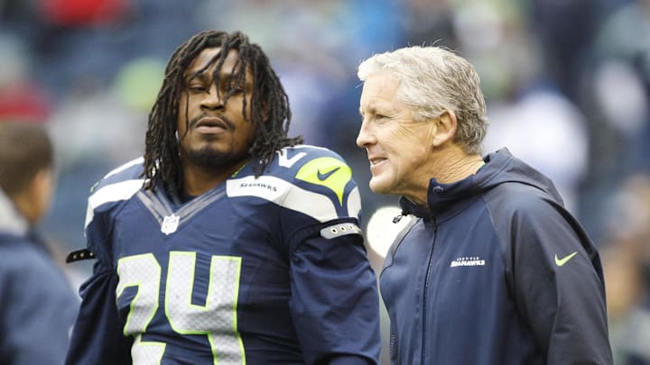 Former Seattle Seahawks head coach Pete Carroll talks with running back Marshawn Lynch during a pregame in 2013. Former Seattle Seahawks head coach Pete Carroll talks with running back Marshawn Lynch during a pregame in 2013.
