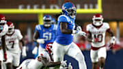 Ole Miss Rebels tight end Dae'Quan Wright (8) runs after a catch as Arkansas Razorback defensive back Miguel Mitchell (16) attempt to make the tackle during the second quarter at Vaught-Hemingway Stadium.