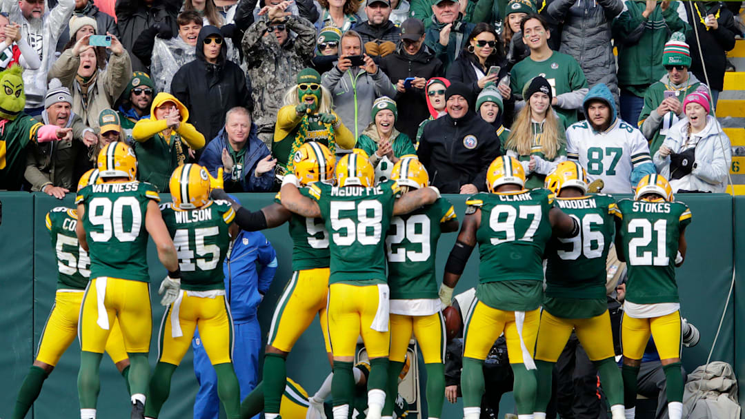 Green Bay Packers players celebrate with fans after defensive tackle Kenny Clark (97) recovered a fumble against the Arizona Cardinals during their football game Sunday, October 13, 2024, at Lambeau Field in Green Bay, Wisconsin.