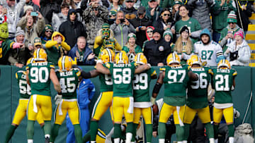 Green Bay Packers players celebrate with fans after defensive tackle Kenny Clark (97) recovered a fumble against the Arizona Cardinals during their football game Sunday, October 13, 2024, at Lambeau Field in Green Bay, Wisconsin.