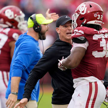 Oklahoma coach Brent Venables talks with Sooners defensive lineman R Mason Thomas (32) during a college football game between the Sooners and Ole Miss at Gaylord Family — Oklahoma Memorial Stadium in Norman on Oct. 25.