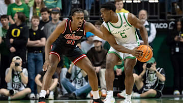 Oregon guard TJ Bamba, right, looks for room to move under cover from Indiana forward Mackenzie Mgbako as the Oregon Ducks host the Indiana Hoosiers Tuesday, March 4, 2025, at Matthew Knight Arena in Eugene, Ore.