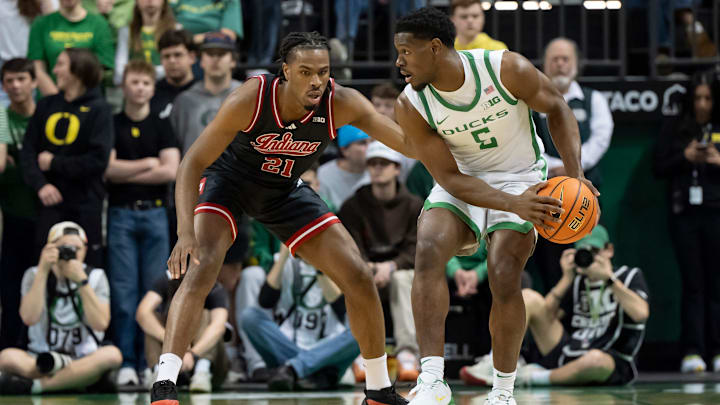Oregon guard TJ Bamba, right, looks for room to move under cover from Indiana forward Mackenzie Mgbako as the Oregon Ducks host the Indiana Hoosiers Tuesday, March 4, 2025, at Matthew Knight Arena in Eugene, Ore.