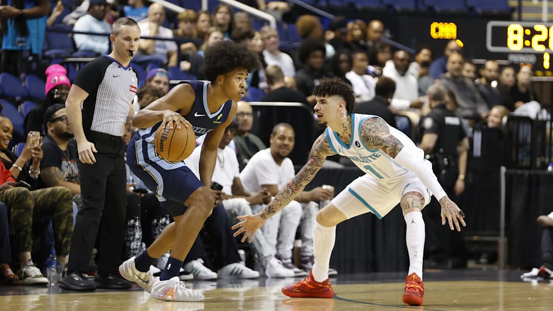 Oct 15, 2025; Greensboro, North Carolina, USA; Memphis Grizzlies forward Jaylen Wells (0) is guarded by Charlotte Hornets guard Lamelo Ball (1) during the first quarter at First Horizon Coliseum. Mandatory Credit: Brian Westerholt-Imagn Images