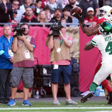 Nov 10, 2024; Glendale, Arizona, USA; Arizona Cardinals wide receiver Marvin Harrison Jr. (18) catches a touchdown pas against New York Jets cornerback D.J. Reed (4) during the first half at State Farm Stadium. Mandatory Credit: Joe Camporeale-Imagn Images