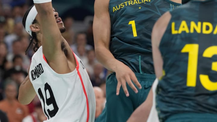 Jul 30, 2024; Villeneuve-d'Ascq, France; Australia point guard Dyson Daniels (1) shoots against Canada point guard Andrew Nembhard (19) in a men's group stage basketball match during the Paris 2024 Olympic Summer Games at Stade Pierre-Mauroy. Mandatory Credit: John David Mercer-USA TODAY Sports