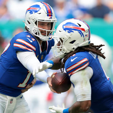 Buffalo Bills QB Josh Allen hands off to RB James Cook III during the first half against the Miami Dolphins.