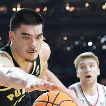 Zach Edey dives for a loose ball with Cam Spencer trailing during Purdue's 75–60 loss to UConn in the national championship on April 8, 2024.