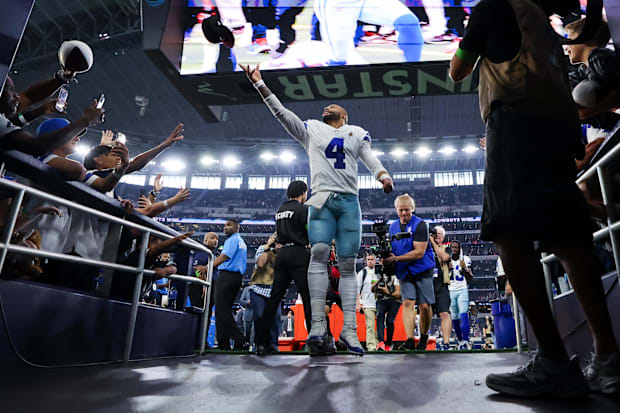 Dallas Cowboys quarterback Dak Prescott celebrates with fans after the game against the New England Patriots.