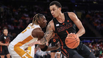 Dec 10, 2024; New York, New York, USA;  Miami Hurricanes center Lynn Kidd (1) looks to drive past Tennessee Volunteers guard Jahmai Mashack (15) in the second half at Madison Square Garden. Mandatory Credit: Wendell Cruz-Imagn Images