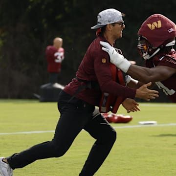 Jul 23, 2025; Ashburn, VA, USA; Washington Commanders defensive tackle Deatrich Wise Jr. (91) participates in a drill with Commanders pass rush specialist/assistant linebackers coach Ryan Kerrigan during practice on day one of training camp at OrthoVirginia Training Center at Commanders Park. Mandatory Credit: Geoff Burke-Imagn Images