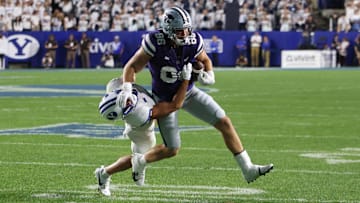Sep 21, 2024; Provo, Utah, USA; Kansas State Wildcats tight end Garrett Oakley (86) runs the ball defended by Brigham Young Cougars safety Crew Wakley (7) during the third quarter at LaVell Edwards Stadium. Mandatory Credit: Rob Gray-Imagn Images