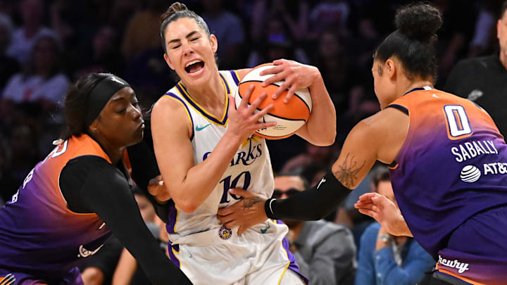 Aug 26, 2025; Los Angeles, California, USA; Los Angeles Sparks guard Kelsey Plum (10) is defended by Phoenix Mercury guard Kahleah Copper (2) and forward Satou Sabally (0) during the second half at Crypto.com Arena. Mandatory Credit: Jayne Kamin-Oncea-Imagn Images