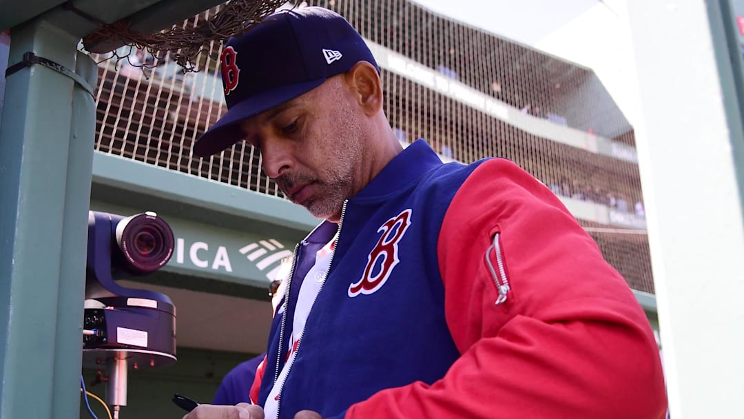 Apr 20, 2026; Boston, Massachusetts, USA; Boston Red Sox manager Alex Cora signs a baseball for a fan prior to a game against the Detroit Tigers at Fenway Park. Mandatory Credit: Bob DeChiara-Imagn Images