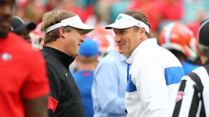 Nov 2, 2019; Jacksonville, FL, USA; Georgia Bulldogs head coach Kirby Smart (left) and Florida Gators head coach Dan Mullen greet prior to a game at TIAA Bank Field. Mandatory Credit: Kim Klement-Imagn Images