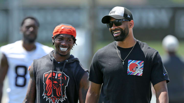 Browns general manager Andrew Berry, right, shares a laugh with cornerback Justin Hardee Sr. after minicamp practice, Thursday, June 13, 2024, in Berea.