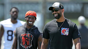 Browns general manager Andrew Berry, right, shares a laugh with cornerback Justin Hardee Sr. after minicamp practice June 13, 2024, in Berea.