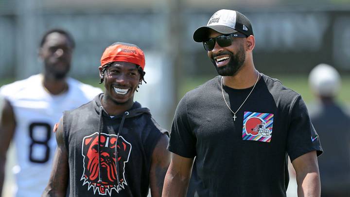 Browns general manager Andrew Berry, right, shares a laugh with cornerback Justin Hardee Sr. after minicamp practice June 13, 2024, in Berea.
