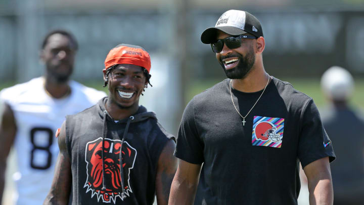 Browns general manager Andrew Berry, right, shares a laugh with cornerback Justin Hardee Sr. after minicamp practice, Thursday, June 13, 2024, in Berea.