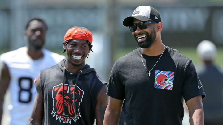 Browns general manager Andrew Berry, right, shares a laugh with cornerback Justin Hardee Sr. after minicamp practice, Thursday, June 13, 2024, in Berea.