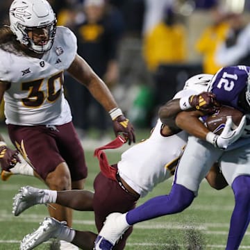 Nov 16, 2024; Manhattan, Kansas, USA; Kansas State Wildcats wide receiver Tre Spivey (12) is tackled by Arizona State Sun Devils defensive back Javan Robinson (12) during the fourth quarter at Bill Snyder Family Football Stadium. Mandatory Credit: Scott Sewell-Imagn Images