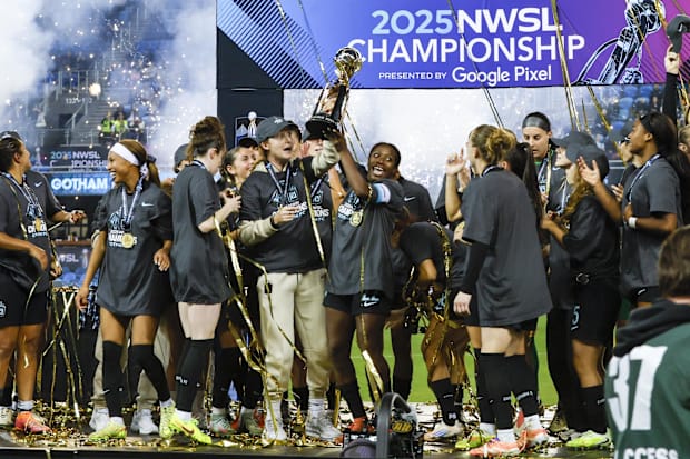 Gotham FC defender Mandy Freeman celebrates with the NWSL trophy.