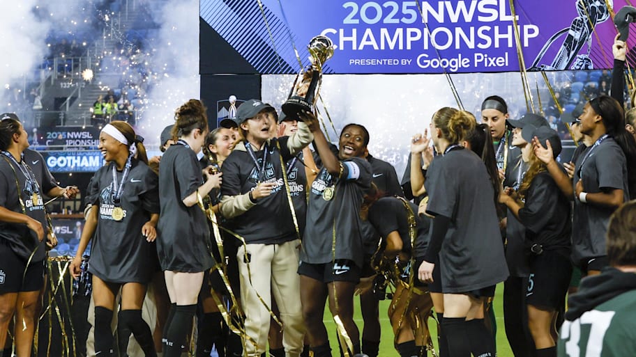 Gotham FC defender Mandy Freeman celebrates with the NWSL trophy.