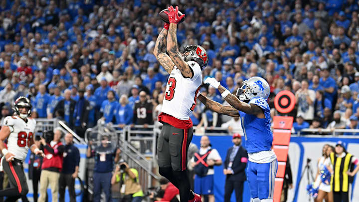 Jan 21, 2024; Detroit, Michigan, USA; Tampa Bay Buccaneers wide receiver Mike Evans (13) makes a catch against Detroit Lions cornerback Cameron Sutton (1) during the second half in a 2024 NFC divisional round game at Ford Field. Mandatory Credit: Lon Horwedel-Imagn Images