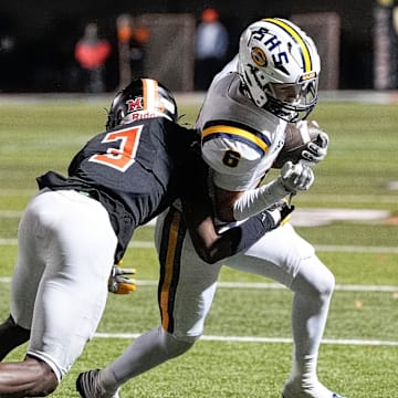 Belleville defensive back Charles Britton III tackles Saline's Nolan Klein during the first half of district final at Belleville High School in Belleville on Friday, Nov. 8, 2024.