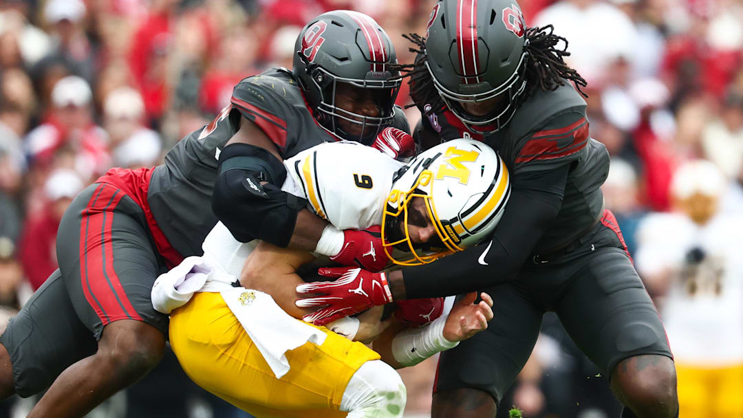 Nov 22, 2025; Norman, Oklahoma, USA;  Oklahoma Sooners linebacker Kendal Daniels (5) tackles Missouri Tigers quarterback Beau Pribula (9) during the second half at Gaylord Family-Oklahoma Memorial Stadium. Mandatory Credit: Kevin Jairaj-Imagn Images