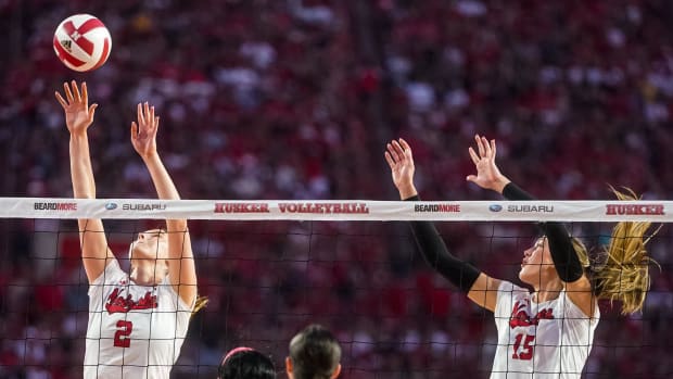 Nebraska Cornhuskers setter Bergen Reilly (2) and middle blocker Andi Jackson (15) go up for a block against the Omaha Maveri