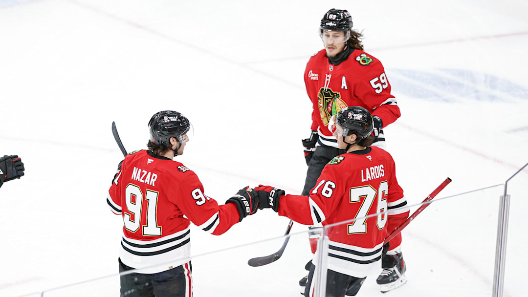 Mar 22, 2026; Chicago, Illinois, USA; Chicago Blackhawks left wing Nick Lardis (76) celebrates with teammates after scoring a goal against the Nashville Predators during the second period at United Center. Mandatory Credit: Kamil Krzaczynski-Imagn Images