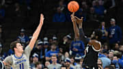 Feb 13, 2024; Omaha, Nebraska, USA;  Georgetown Hoyas forward Supreme Cook (24) scores over Creighton Bluejays center Ryan Kalkbrenner (11) in the second half at CHI Health Center Omaha. Mandatory Credit: Steven Branscombe-Imagn Images