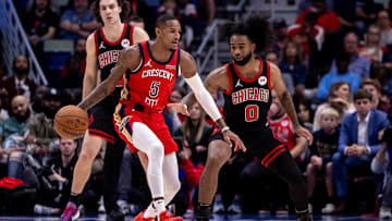 Oct 23, 2024; New Orleans, Louisiana, USA;  New Orleans Pelicans guard Dejounte Murray (5) dribbles against Chicago Bulls guard Coby White (0) during the first half at Smoothie King Center. Mandatory Credit: Stephen Lew-Imagn Images