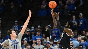 Feb 13, 2024; Omaha, Nebraska, USA;  Georgetown Hoyas forward Supreme Cook (24) scores over Creighton Bluejays center Ryan Kalkbrenner (11) in the second half at CHI Health Center Omaha. Mandatory Credit: Steven Branscombe-Imagn Images