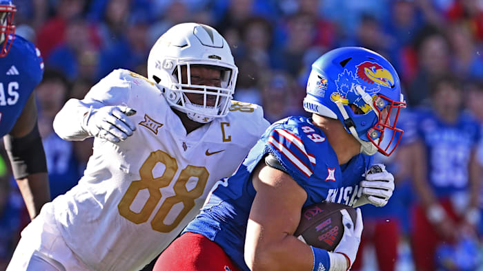 Oct 7, 2023; Lawrence, Kansas, USA; UCF Knights defensive end Josh Celiscar (88) tackles Kansas