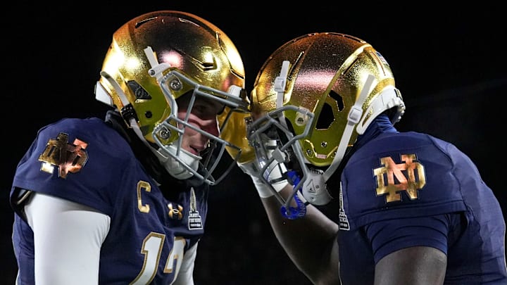 Notre Dame Fighting Irish quarterback Riley Leonard and running back Jeremiyah Love celebrate a touchdown.