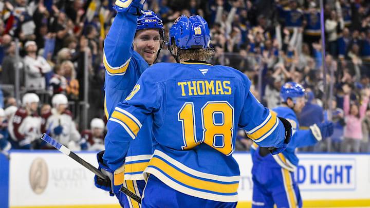 Apr 5, 2025; St. Louis, Missouri, USA;  St. Louis Blues center Robert Thomas (18) is congratulated by center Radek Faksa (12) after scoring an empty net goal against the Colorado Avalanche at Enterprise Center. The Blues would go on to defeat the Avalanche and record a franchise record 12th straight win. Mandatory Credit: Jeff Curry-Imagn Images
