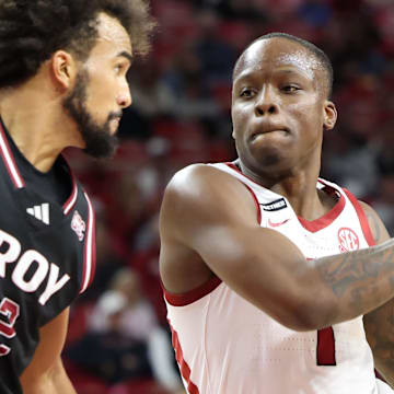 Arkansas Razorbacks guard Nelly Davis (1) drives against Troy Trojans guard Tayton Conway (12) during the second half at Bud Walton Arena last Wednesday. Arkansas won 65-49. The Hogs return to the court Friday against Little Rock.