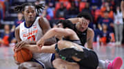 Dec 29, 2024; Champaign, Illinois, USA;  Illinois Fighting Illini forward Morez Johnson Jr. (21) and Chicago State Cougars guard Gabe Spinelli (12) wrestle for a loose ball during the first half at State Farm Center. Mandatory Credit: Ron Johnson-Imagn Images