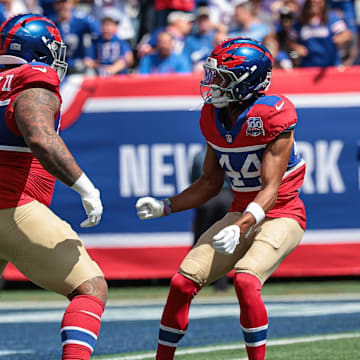 Sep 8, 2024; East Rutherford, New Jersey, USA; New York Giants defensive tackle Dexter Lawrence II (97) celebrates his sack with cornerback Nick McCloud (44) during the first quarter against the Minnesota Vikings at MetLife Stadium.  