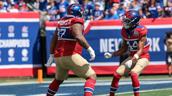 Sep 8, 2024; East Rutherford, New Jersey, USA; New York Giants defensive tackle Dexter Lawrence II (97) celebrates his sack with cornerback Nick McCloud (44) during the first quarter against the Minnesota Vikings at MetLife Stadium.  