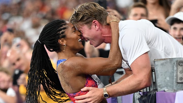 Tara Davis-Woodhall celebrates with her husband Hunter Woodhall after winning the women's long jump final of the athletics event at the Paris 2024 Olympic Games at Stade de France in Saint-Denis, north of Paris, on August 8, 2024.