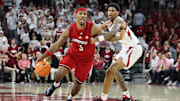 Dec 3, 2025; Fayetteville, Arkansas, USA; Louisville Cardinals guard Ryan Conwell (3) dribbles around Arkansas Razorbacks guard Meleek Thomas (1) during the second half at Bud Walton Arena. Arkansas won 89-80. Mandatory Credit: Nelson Chenault-Imagn Images