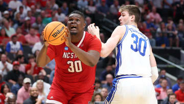 Mar 31, 2024; Dallas, TX, USA; North Carolina State Wolfpack forward DJ Burns Jr. (30) controls the ball against Duke Blue Devils center Kyle Filipowski (30) in the second half in the finals of the South Regional of the 2024 NCAA Tournament at American Airline Center. Mandatory Credit: Kevin Jairaj-USA TODAY Sports