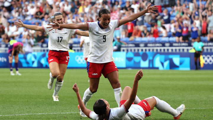 Sophia Smith of the United States celebrates with Trinity Rodman after scoring a goal against Germany in a women's football semifinal match during the Paris 2024 Olympic Summer Games at Lyon Stadium.