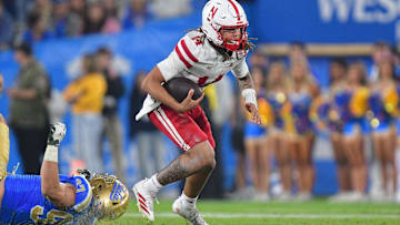 Nebraska quarterback TJ Lateef carries the ball during the second half against UCLA.
