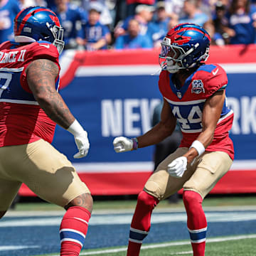 Sep 8, 2024; East Rutherford, New Jersey, USA; New York Giants defensive tackle Dexter Lawrence II (97) celebrates his sack with cornerback Nick McCloud (44) during the first quarter against the Minnesota Vikings at MetLife Stadium.