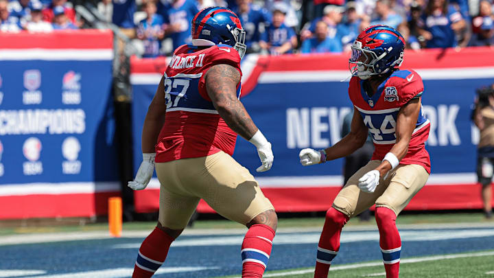 Sep 8, 2024; East Rutherford, New Jersey, USA; New York Giants defensive tackle Dexter Lawrence II (97) celebrates his sack with cornerback Nick McCloud (44) during the first quarter against the Minnesota Vikings at MetLife Stadium.