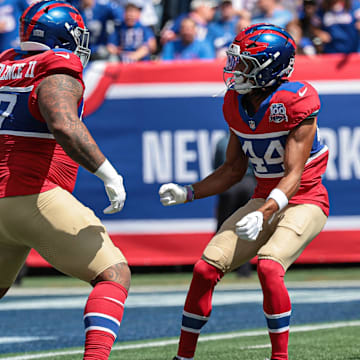 Sep 8, 2024; East Rutherford, New Jersey, USA; New York Giants defensive tackle Dexter Lawrence II (97) celebrates his sack with cornerback Nick McCloud (44) during the first quarter against the Minnesota Vikings at MetLife Stadium.  